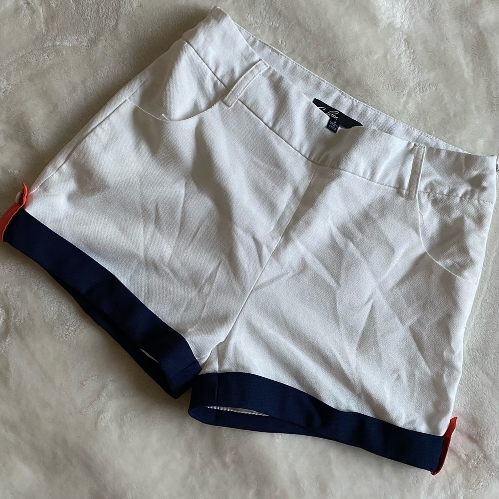 Waisted white shorts with navy stripes and orange button design on sides